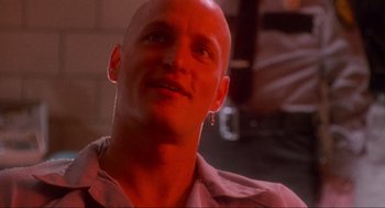 Movie still from “Natural Born Killers” (1994), directed by Oliver Stone – A man with a shaved head looking up at the sky; Close Up shot, Low angle