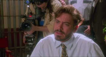 Movie still from “Natural Born Killers” (1994), directed by Oliver Stone – A person wearing a tie; Close Up shot, Over the shoulder angle