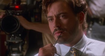 Movie still from “Natural Born Killers” (1994), directed by Oliver Stone – A person with a tie; Close Up shot, Over the shoulder angle