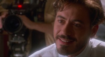 Movie still from “Natural Born Killers” (1994), directed by Oliver Stone – A person with a beard; Close Up shot, Over the shoulder angle