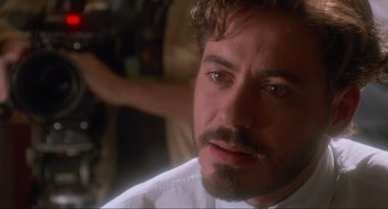 Movie still from “Natural Born Killers” (1994), directed by Oliver Stone – A person with a beard; Close Up shot, Over the shoulder angle