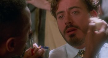 Movie still from “Natural Born Killers” (1994), directed by Oliver Stone – A person cutting his hair; Close Up shot, Over the shoulder angle