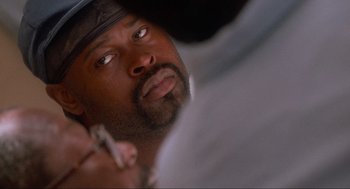 Movie still from “Natural Born Killers” (1994), directed by Oliver Stone – A person holding a cell phone; Close Up shot, Over the shoulder angle