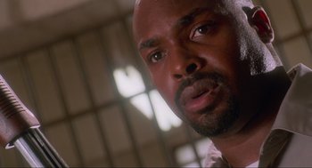 Movie still from “Natural Born Killers” (1994), directed by Oliver Stone – A man's face in front of a window; Close Up shot, Low angle