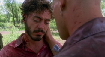 Movie still from “Natural Born Killers” (1994), directed by Oliver Stone – A man with blood all over his face and neck; Close Up shot, Over the shoulder angle