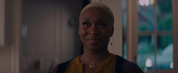 Movie still from “Needle in a Timestack” (2021), directed by John Ridley – A person wearing a necklace; Close Up shot, Over the shoulder angle