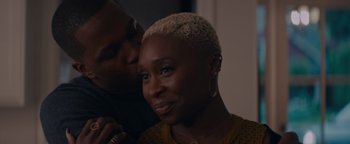 Movie still from “Needle in a Timestack” (2021), directed by John Ridley – A man kissing a woman on the cheek; Close Up shot, Over the shoulder angle