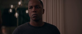 Movie still from “Needle in a Timestack” (2021), directed by John Ridley – A person wearing a black shirt; Close Up shot, Over the shoulder angle