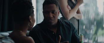 Movie still from “Needle in a Timestack” (2021), directed by John Ridley – A man talking to a woman in a room; Close Up shot, Over the shoulder angle