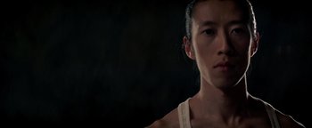 Movie still from “Needle in a Timestack” (2021), directed by John Ridley – A person's face in a dark room; Close Up shot, Low angle