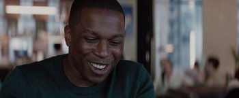 Movie still from “Needle in a Timestack” (2021), directed by John Ridley – A person smiling with his eyes closed; Close Up shot, Over the shoulder angle
