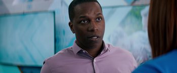 Movie still from “Needle in a Timestack” (2021), directed by John Ridley – A person wearing a purple shirt; Close Up shot, Over the shoulder angle