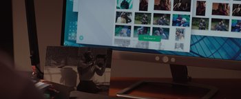 Movie still from “Needle in a Timestack” (2021), directed by John Ridley – A person taking a picture of a picture on a computer screen; Extreme Close Up shot, Over the shoulder angle