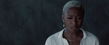 Movie still from “Needle in a Timestack” (2021), directed by John Ridley – An older black woman with short grey hair looking sad; Close Up shot, Over the shoulder angle