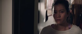 Movie still from “Needle in a Timestack” (2021), directed by John Ridley – A young woman is standing in a room; Close Up shot, Low angle