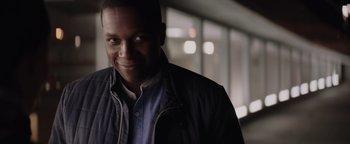 Movie still from “Needle in a Timestack” (2021), directed by John Ridley – A person wearing a jacket; Close Up shot, Over the shoulder angle