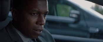 Movie still from “Needle in a Timestack” (2021), directed by John Ridley – A person in a car; Close Up shot, Over the shoulder angle