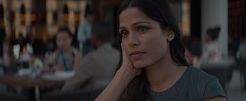 Movie still from “Needle in a Timestack” (2021), directed by John Ridley – A beautiful young woman with long dark hair; Close Up shot, Over the shoulder angle