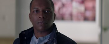Movie still from “Needle in a Timestack” (2021), directed by John Ridley – A person wearing a jacket; Close Up shot, Over the shoulder angle