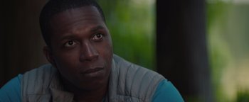 Movie still from “Needle in a Timestack” (2021), directed by John Ridley – A person wearing a vest; Close Up shot, Over the shoulder angle