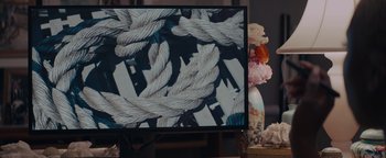 Movie still from “Needle in a Timestack” (2021), directed by John Ridley – A television screen with a picture of ropes on it; Extreme Close Up shot, High angle
