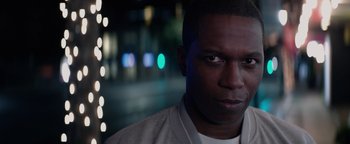 Movie still from “Needle in a Timestack” (2021), directed by John Ridley – A person wearing a white shirt; Close Up shot, Over the shoulder angle
