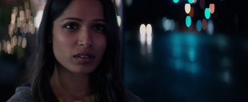Movie still from “Needle in a Timestack” (2021), directed by John Ridley – A woman's face at night; Close Up shot, Over the shoulder angle