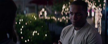 Movie still from “Needle in a Timestack” (2021), directed by John Ridley – A person wearing a white shirt; Close Up shot, Over the shoulder angle