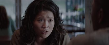 Movie still from “Needle in a Timestack” (2021), directed by John Ridley – A person with long black hair; Close Up shot, Over the shoulder angle