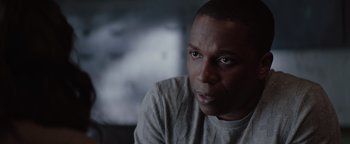 Movie still from “Needle in a Timestack” (2021), directed by John Ridley – A person looking at the camera; Close Up shot, Over the shoulder angle