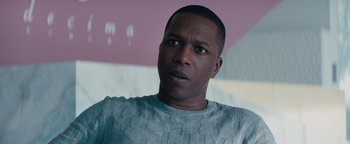 Movie still from “Needle in a Timestack” (2021), directed by John Ridley – A person wearing a sweater; Close Up shot, Low angle