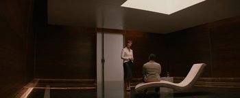 Movie still from “Needle in a Timestack” (2021), directed by John Ridley – A woman standing next to a man in a room; Wide shot, Over the shoulder angle