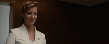 Movie still from “Needle in a Timestack” (2021), directed by John Ridley – A woman in a white shirt smiling for the camera; Close Up shot, Low angle