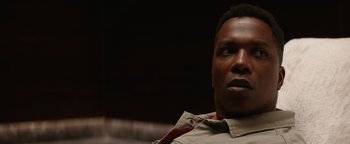 Movie still from “Needle in a Timestack” (2021), directed by John Ridley – A person wearing a jacket; Close Up shot, Low angle