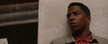 Movie still from “Needle in a Timestack” (2021), directed by John Ridley – A person wearing a jacket; Close Up shot, Low angle