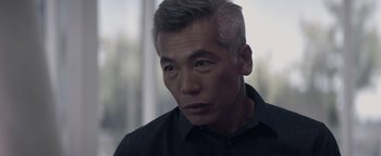 Movie still from “Needle in a Timestack” (2021), directed by John Ridley – A person wearing a black shirt; Close Up shot, Over the shoulder angle