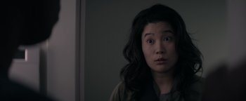 Movie still from “Needle in a Timestack” (2021), directed by John Ridley – A woman with long black hair looking at the camera; Close Up shot, Over the shoulder angle