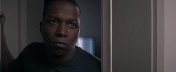 Movie still from “Needle in a Timestack” (2021), directed by John Ridley – A man's face in front of a mirror; Close Up shot, Low angle