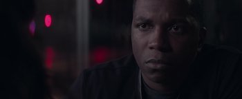 Movie still from “Needle in a Timestack” (2021), directed by John Ridley – A man's face in front of a blurry background; Close Up shot, Low angle