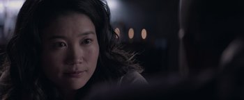 Movie still from “Needle in a Timestack” (2021), directed by John Ridley – A person with long hair; Close Up shot, Over the shoulder angle