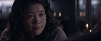 Movie still from “Needle in a Timestack” (2021), directed by John Ridley – A woman's face in the dark; Close Up shot, Over the shoulder angle