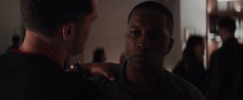 Movie still from “Needle in a Timestack” (2021), directed by John Ridley – A man with his arm around another mans shoulder; Close Up shot, Over the shoulder angle