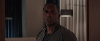 Movie still from “Needle in a Timestack” (2021), directed by John Ridley – A person wearing a jacket; Close Up shot, Over the shoulder angle