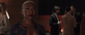 Movie still from “Needle in a Timestack” (2021), directed by John Ridley – A woman with a shaved head and a man in a suit; Close Up shot, Over the shoulder angle