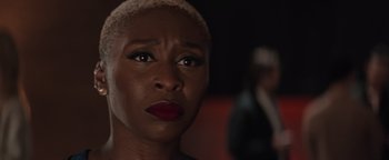 Movie still from “Needle in a Timestack” (2021), directed by John Ridley – A person with short blonde hair; Close Up shot, Over the shoulder angle