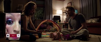 Movie still from “Neighbors” (2014), directed by Nicholas Stoller – A man and a woman playing with a baby in a living room; Medium shot, Overhead angle