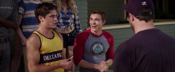 Movie still from “Neighbors” (2014), directed by Nicholas Stoller – A group of young men standing next to each other; Medium shot, Over the shoulder angle