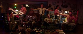 Movie still from “Neighbors” (2014), directed by Nicholas Stoller – A group of people sitting around a living room; Wide shot, Low angle
