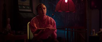 Movie still from “Neighbors” (2014), directed by Nicholas Stoller – A man sitting in front of a lamp in a dark room; Medium shot, Low angle