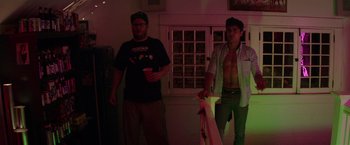 Movie still from “Neighbors” (2014), directed by Nicholas Stoller – Two men standing next to each other in front of a window; Medium shot, Over the shoulder angle